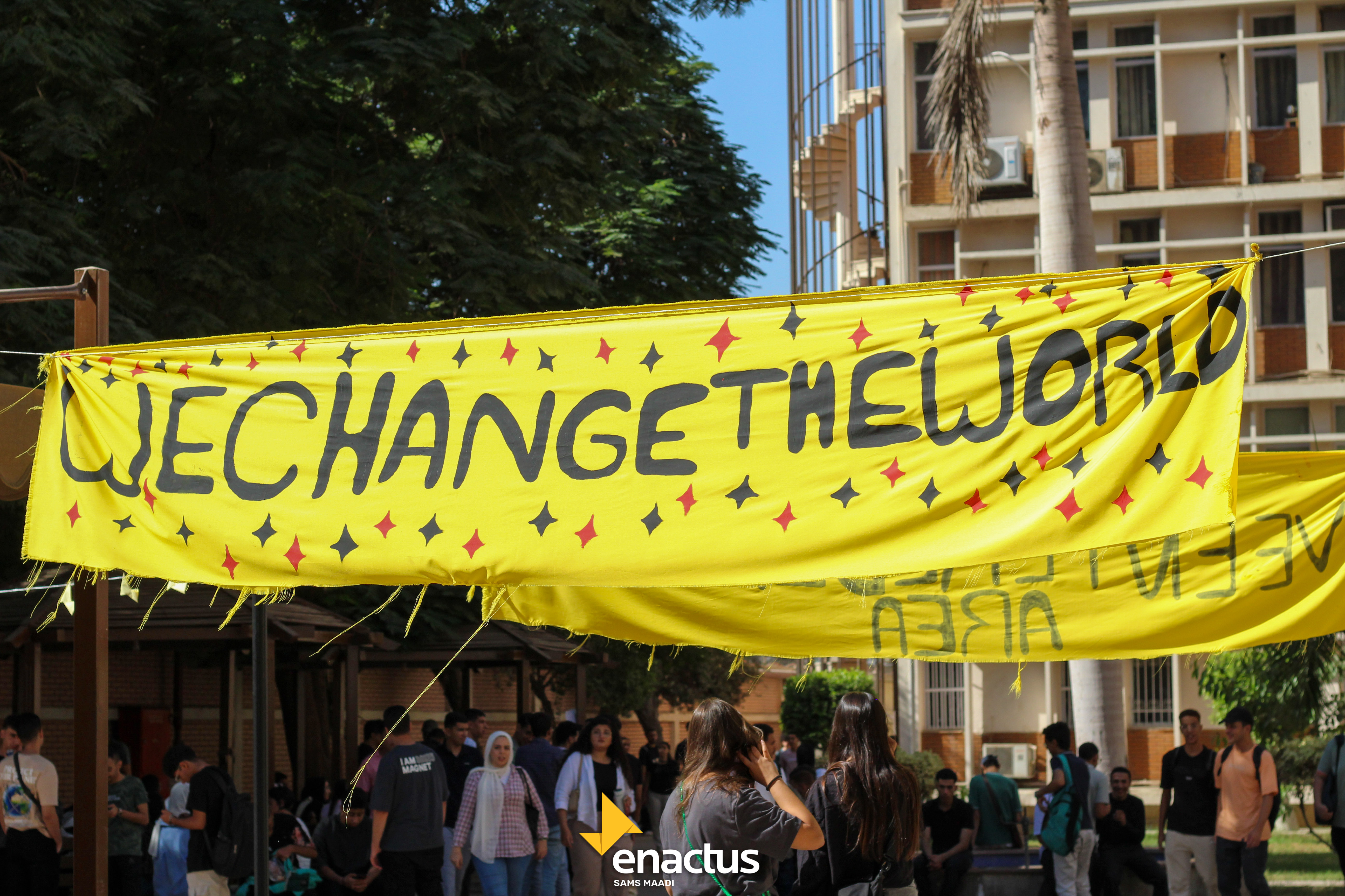 The WE CHANGE THE WORLD banner on campus