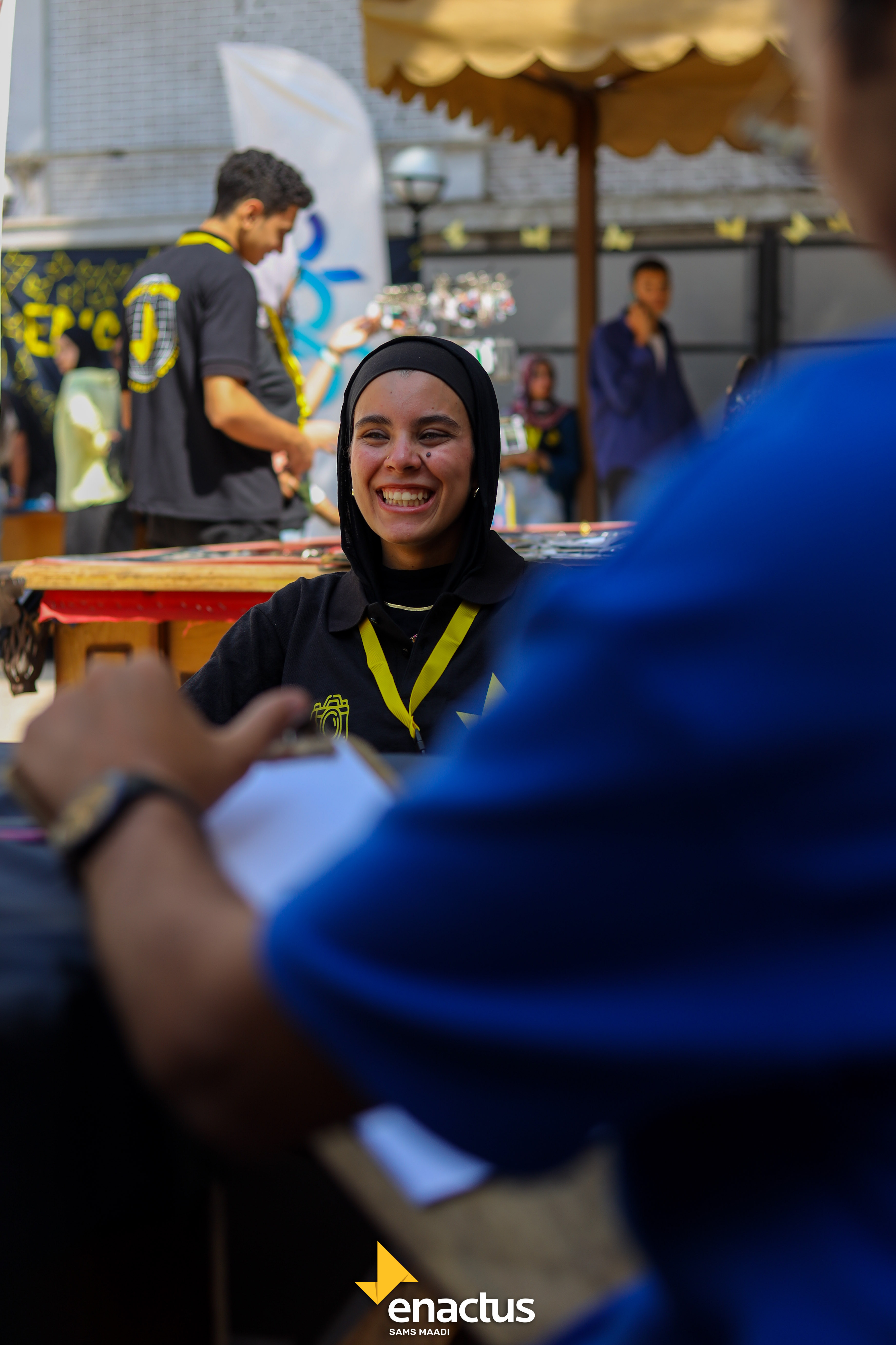 A member laughing behind the booth table
