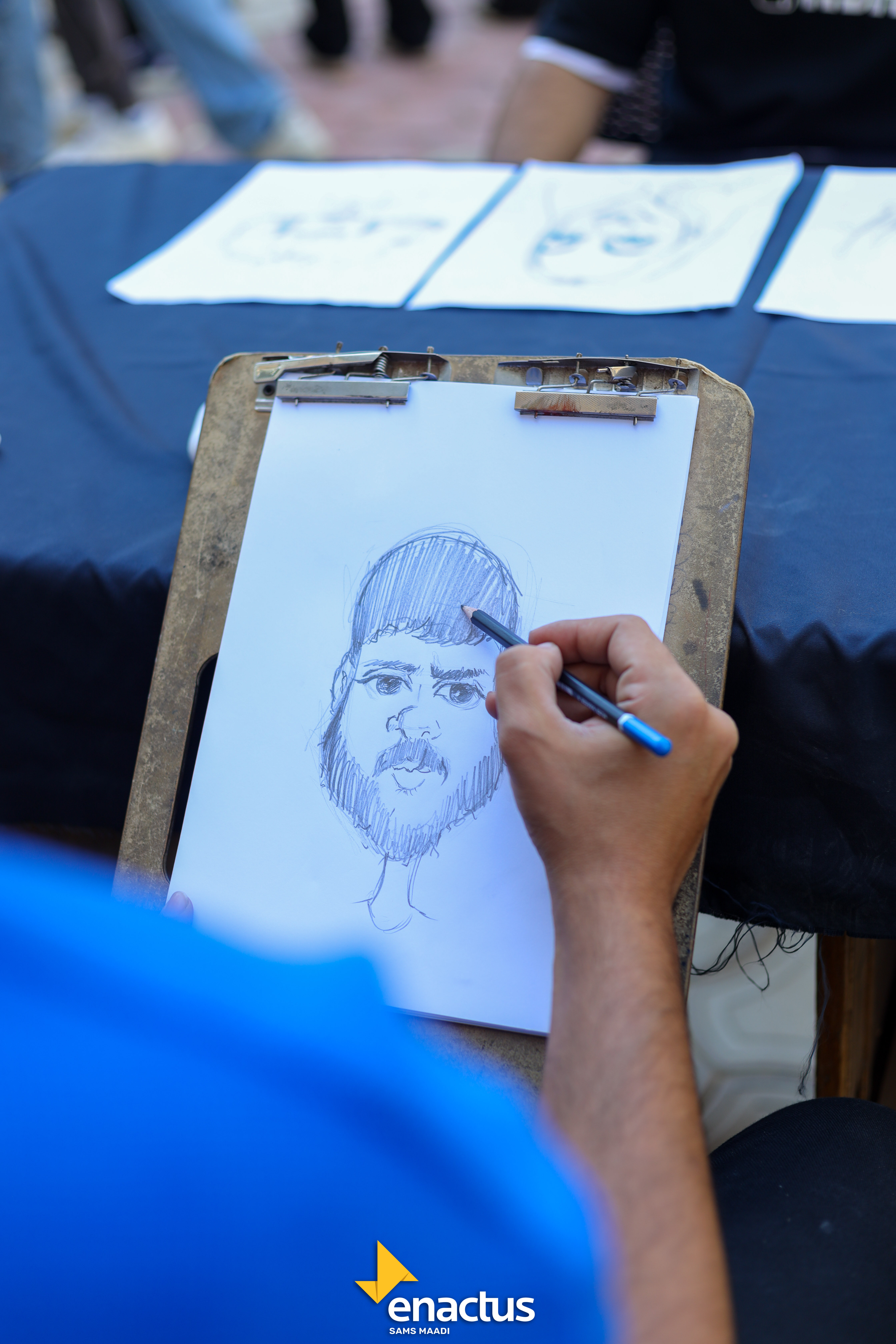 A caricature being drawn at the booth